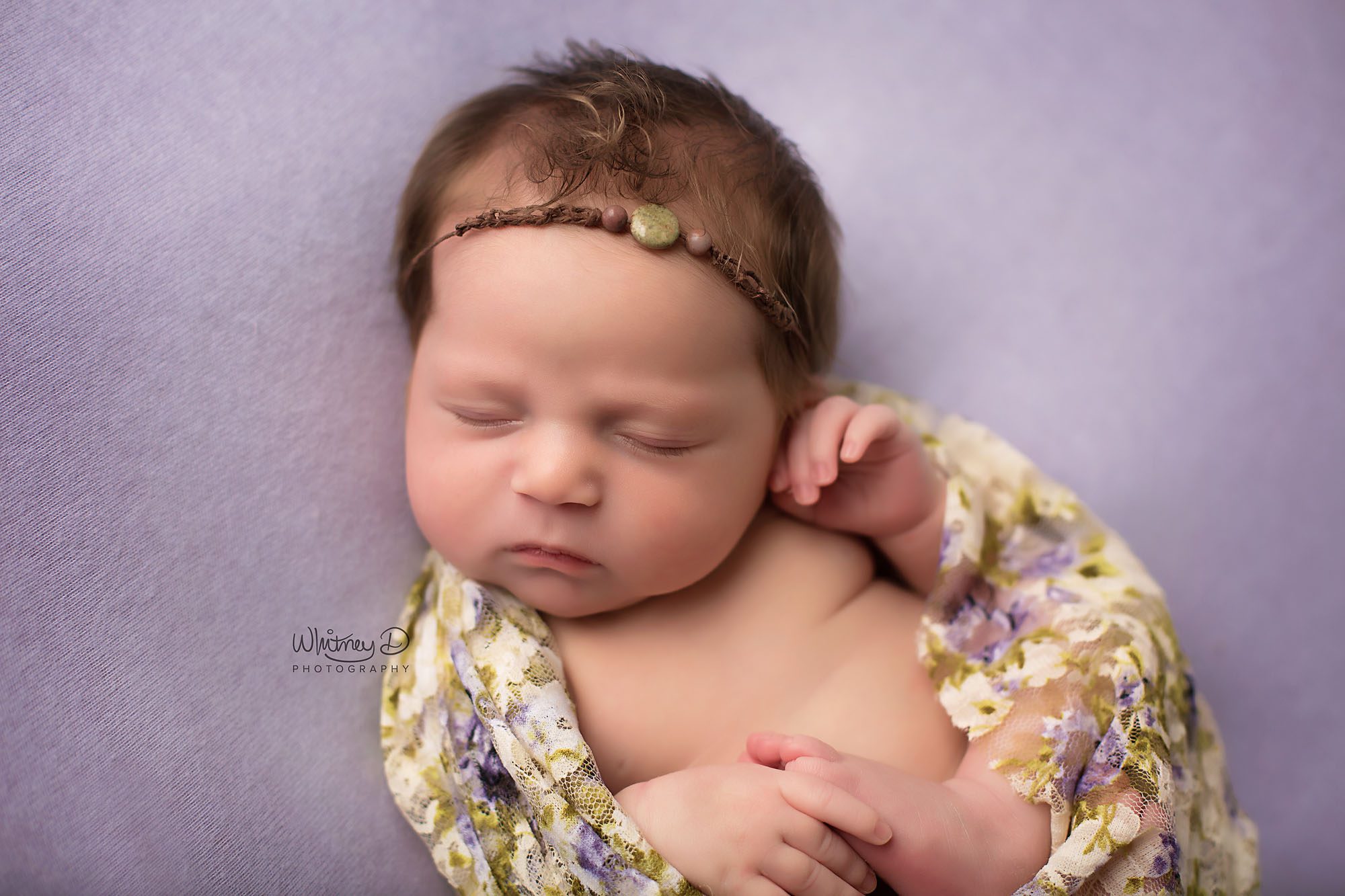Newborn baby girl in floral wrap