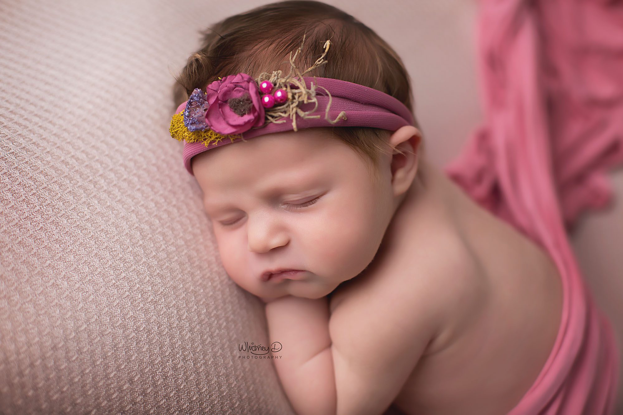 Newborn baby girl with floral headband