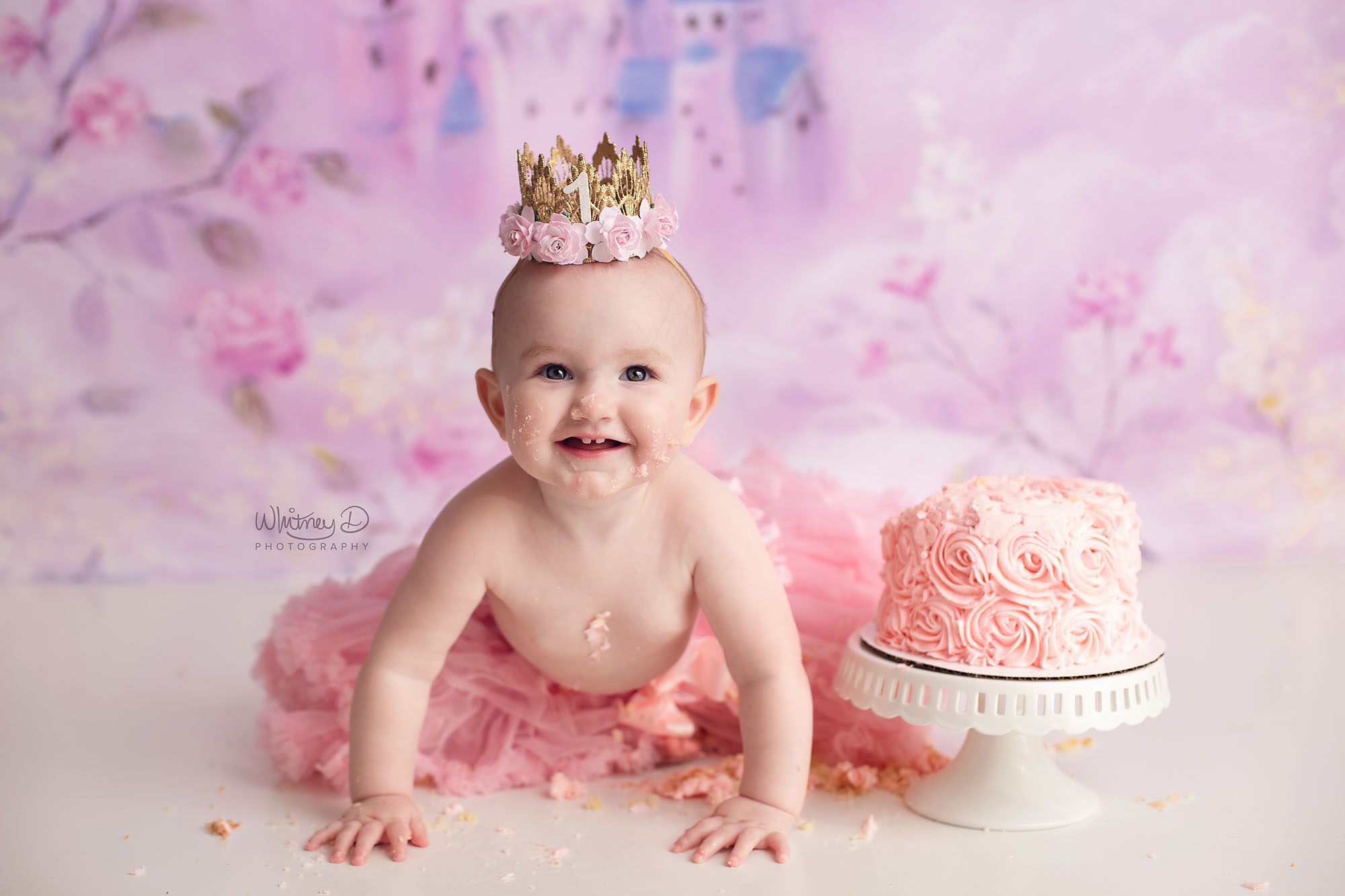 Princess Baby Girl in pink eating cake for first birthday at Whitney D. Photography in Conway, Arkansas