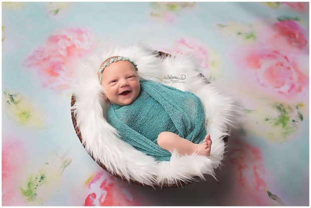 Smiling Newborn on floral background