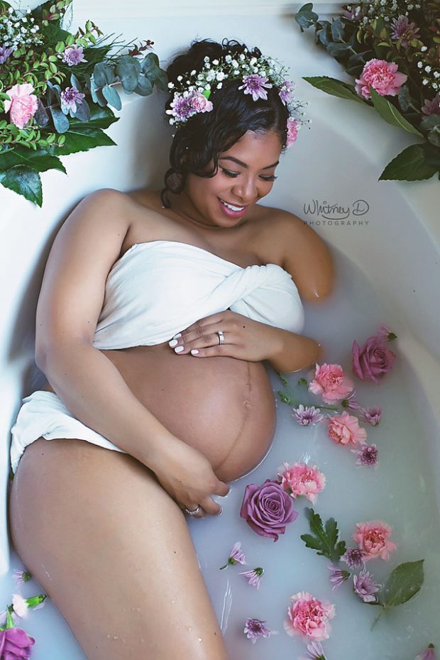 Gorgeous mom in milk bath surrounded by flowers