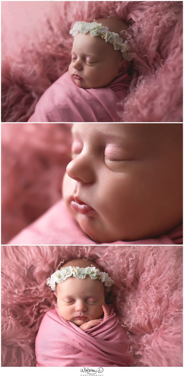 Newborn in pink wrap smiling at Whitney D. Photography in Conway, Arkansas