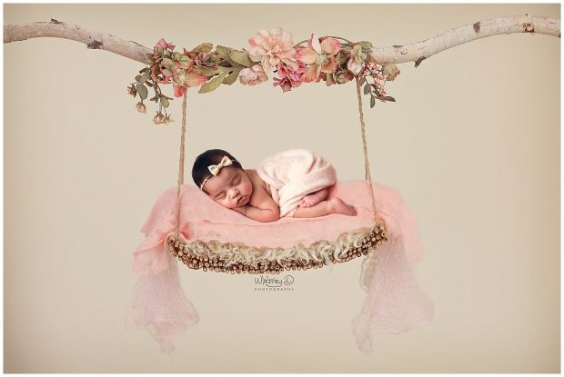 Newborn baby on a swing at Whitney D. Photography in Conway, Arkansas