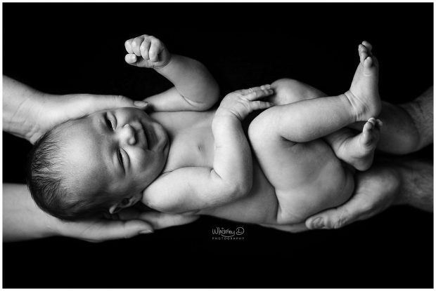 Newborn in parents hands at Whitney D. Photography in Conway, Arkansas
