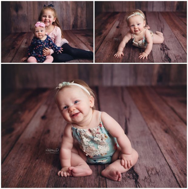 Six month old baby girl smiling on wood backdrop at Whitney D. Photography in Conway, Arkansas