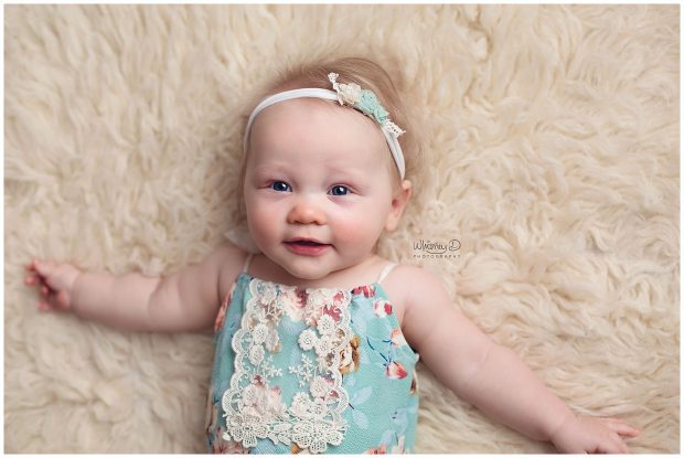 Six month old baby on cream rug at Whitney D. Photography in Conway, Arkansas