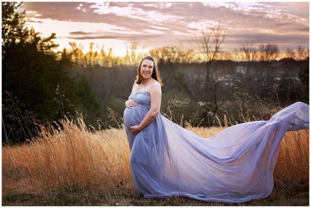 Pregnant woman in maternity gown in front of beautiful sunset with Whitney D. Photography in Conway, Arkansas
