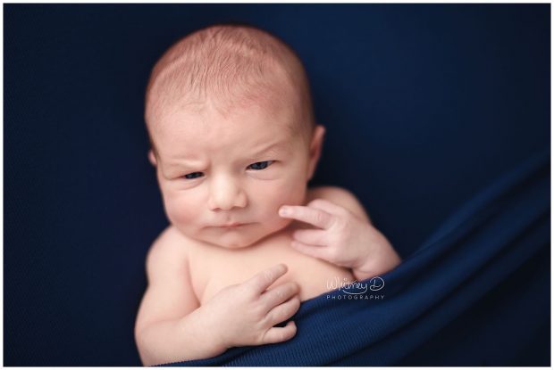 Newborn baby boy flipping off at Whitney D. Photography in Conway, Arkansas