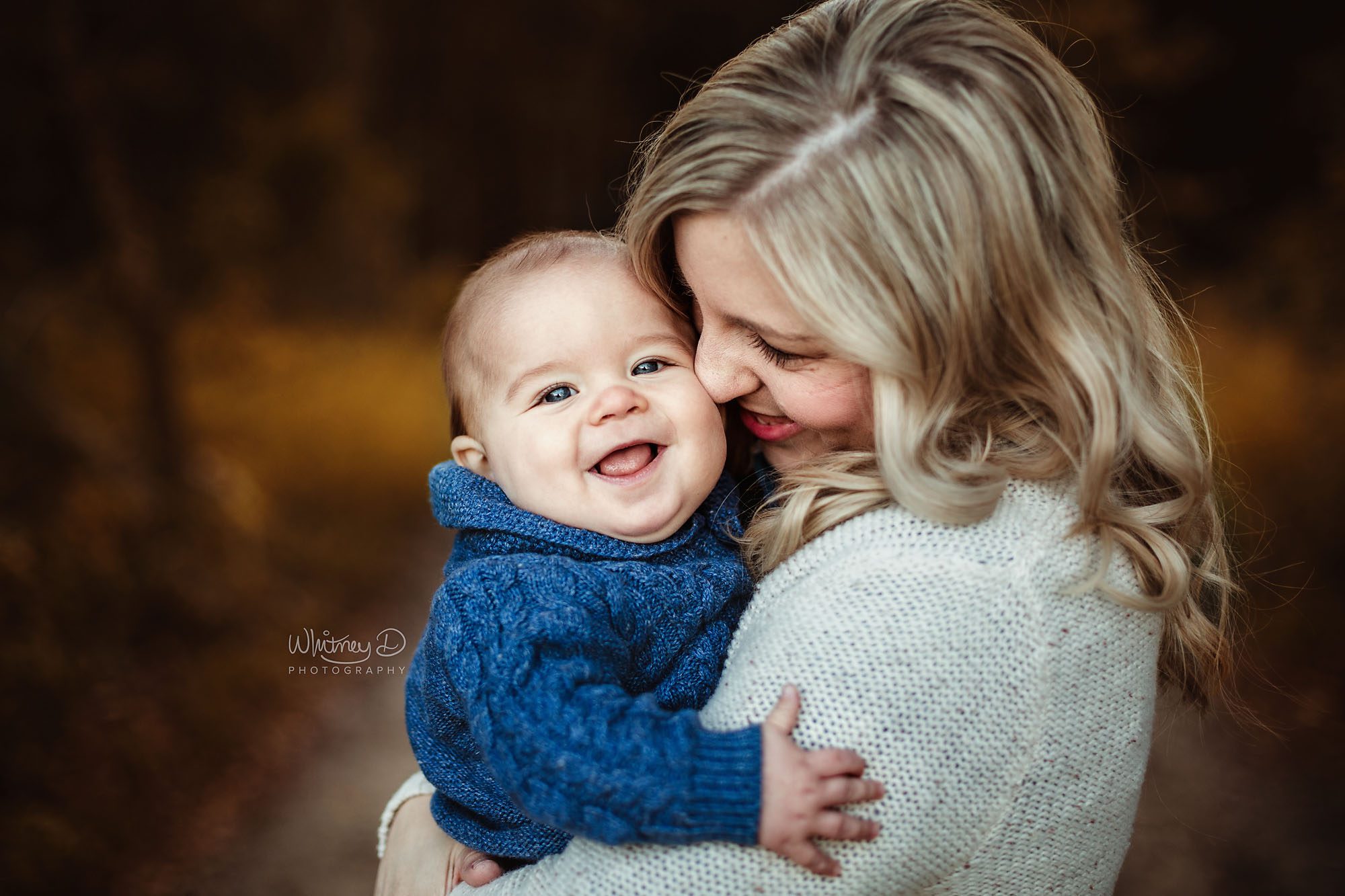 Mom nuzzling baby boy for family photo